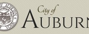 The official logo and seal for the City of Auburn, New York, on a textured background.