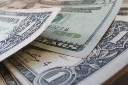 Close-up of US dollar bills, including one and twenty dollar denominations.