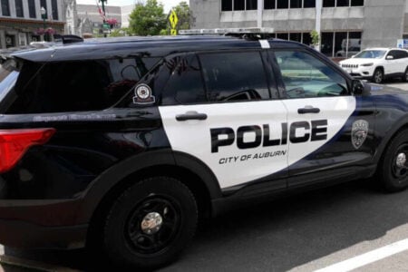 A black and white Auburn Police Department SUV cruiser parked on a street.