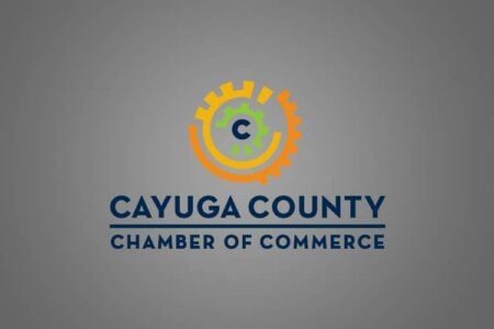 Cayuga County Chamber of Commerce logo with orange, yellow, and green concentric gears and a "C" on a gray background.