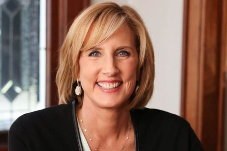 Headshot of U.S. Representative Claudia Tenney, a smiling blonde woman, wearing earrings and a necklace.