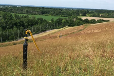 Irrigation pipe and hose on a grassy hillside at Seneca Meadows Landfill in Seneca Falls, NY.