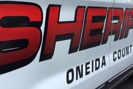 Close-up of the side of an Oneida County Sheriff's vehicle with red lettering.
