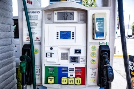 A gas pump displays $36.14 for 12.91 gallons, with prices for Diesel #2 and unleaded 87, 89, 91.