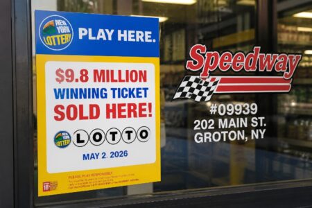 New York Lottery sign on a Speedway store window in Groton, NY, announcing a $9.8 million winning Lotto ticket sold here.