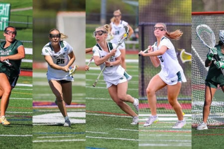 Five William Smith women's lacrosse players in action on a green turf field, including a goalie.