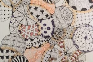 Abstract drawing with overlapping circles and irregular shapes filled with intricate black, white, orange, brown, and purple Zentangle patterns.