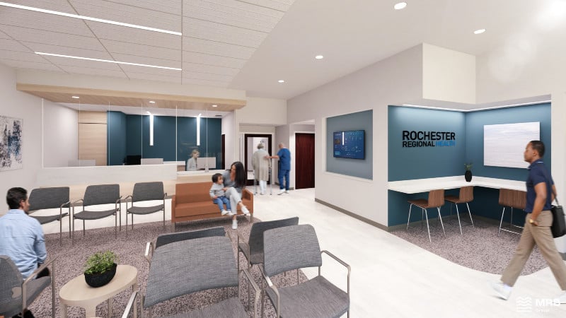 Modern Rochester Regional Health waiting room with patients, staff, a reception desk, and a man walking through.