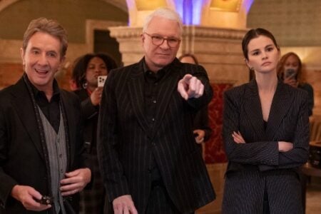 Martin Short smiles, Steve Martin points, and Selena Gomez looks on seriously in a grand hall with a roulette table.
