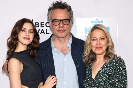 Dark-haired woman, gray-haired man in glasses, and blonde woman pose at the Tribeca Film Festival.