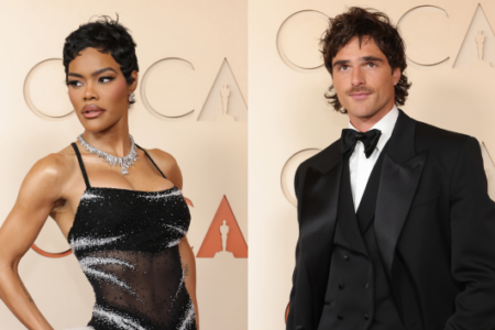 Teyana Taylor in a black beaded gown and diamond necklace next to Jacob Elordi in a black tuxedo and bow tie, at an Oscar event.