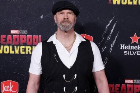 Comic creator Rob Liefeld, in a flat cap and pinstripe vest, poses at the Deadpool & Wolverine premiere.