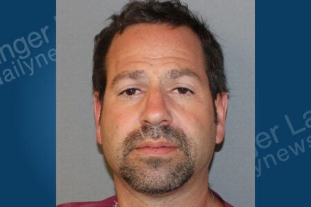 Mugshot of a man with dark hair and a goatee, looking forward against a plain background.