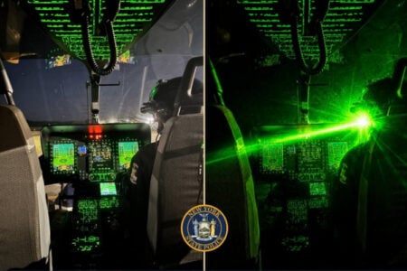 NY State Police pilot in a helicopter cockpit at night, contrasted with a blinding green laser strike.