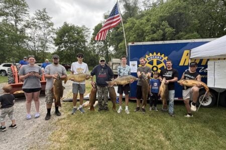 Anglers of all ages display their massive carp catches at the outdoor Rotary Carp Derby 2024.