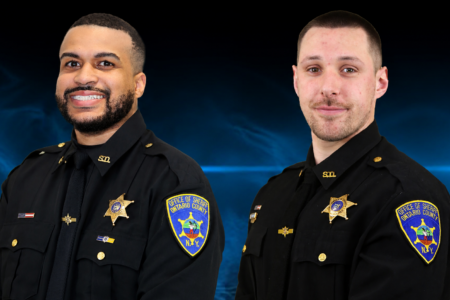 Two Ontario County Sheriff's Deputies in uniform smiling against a blue background.