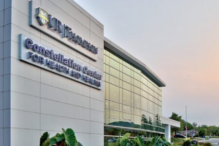 UR Thompson Health Constellation Center for Health and Healing exterior at dusk.