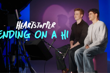 Two young men sit in a purple and blue studio, with filming equipment and "Heartstopper: Ending on a Hi" text.