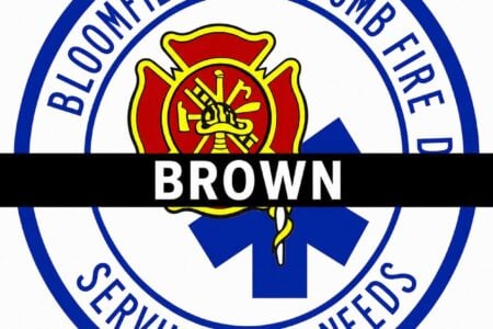 Bloomfield-Holcomb Fire logo featuring a Maltese cross, Star of Life, and a black bar honoring "BROWN.