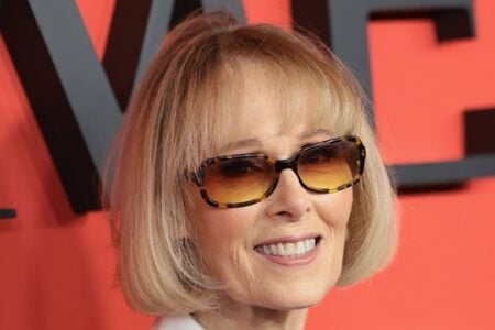 Catherine O'Hara with a blonde bob and tortoiseshell sunglasses smiles against a red background with "TIME" letters.