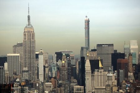 New York City skyline with Empire State, Chrysler, MetLife, and 432 Park Avenue skyscrapers, one under construction.