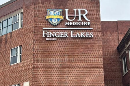 Red brick building displaying the UR Medicine logo and signs for "UR Medicine" and "Finger Lakes Health.