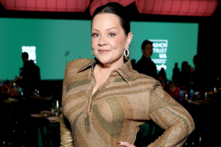 Melissa McCarthy, in a shimmery gold striped shirt, smiles at the Fashion Trust U.S. Awards event.