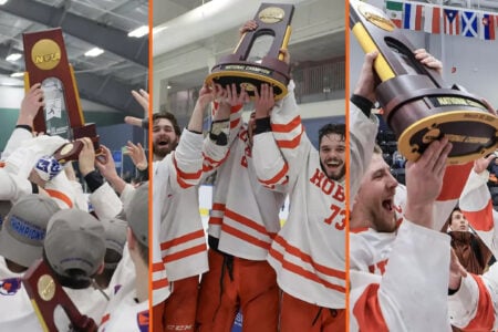 Hobart College hockey players hoist the 2023 NCAA DIII Ice Hockey Championship trophy in celebration.