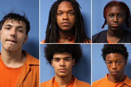 Mugshots of four men and one woman in orange and dark blue attire against a blue background.