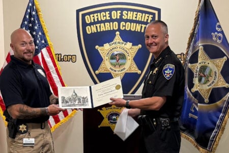 Ontario County Sheriff presents a commendation award and courthouse drawing to Cory Herendeen at the Sheriff's Office.