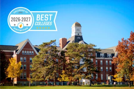 Historic brick college building with cupola and autumn trees on a sunny campus, overlaid with a 'Best Colleges 2026-2027' graphic.
